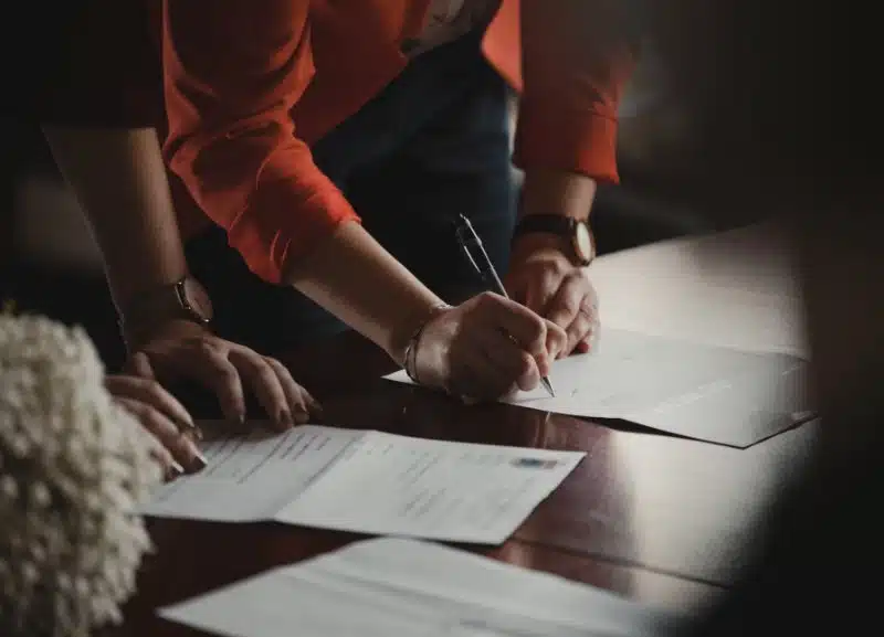 A set of documents placed on a wooden table. 