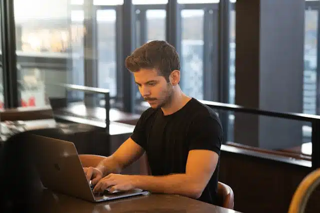 A man researching title loan options on his laptop. 